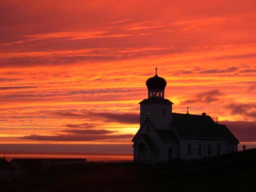 Photo of sunrise behind the Russian Orthodox Church.