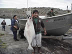 Thumbnail photo of man displaying a freshly caught halibut.