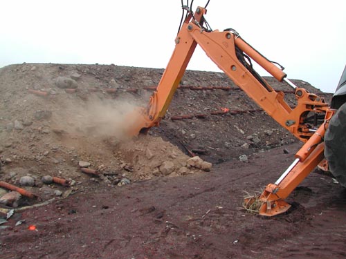 Photo of an excavator sampling at the Enhanced Thermal Conduction Unit.