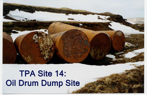 Photo of rusted oil drums in snow at Oil Drum Dump Site.