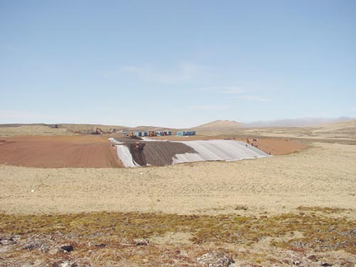 Photo of people covering the liner at the Active Landfill.