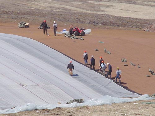 Photo of people laying out liner at the Active Landfill.