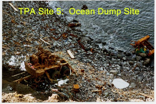 Photo of rusted metal objects on rocky shore at the Ocean Dump Site.