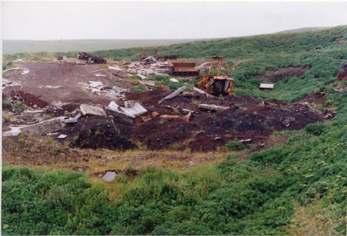 Photo of debris and machinery at the Open Pits Site.