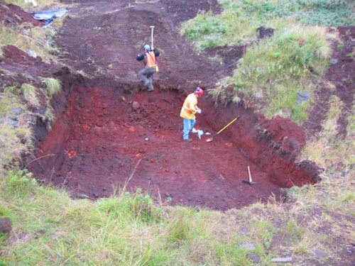 Photo of people in excavated pit at environmental remediation in progress at the Open Pits Site.