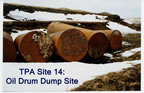 Thumbnail photo of rusted oil drums in snow at Oil Drum Dump Site.