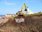 Thumbnail photo of excavation in progress at the Former Fuel Storage Area with church in the background.