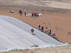 Thumbnail photo of people laying out liner at the Active Landfill.