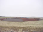 Thumbnail photo of Active Landfill cap construction, a wide low dome of earth.