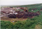Thumbnail photo of debris and machinery at the Open Pits Site.