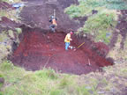 Thumbnail photo of people in excavated pit at environmental remediation in progress at the Open Pits Site.