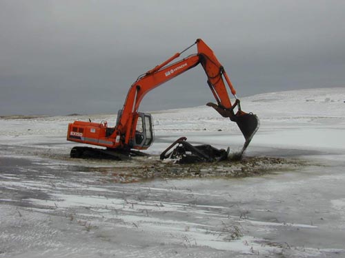 Photo of an excavator removing the Bulldozer in the Bog.
