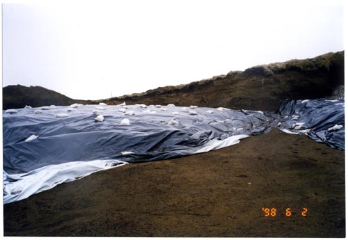 Photo of a tarp covered area at the soil stockpile at Polovina Hill.