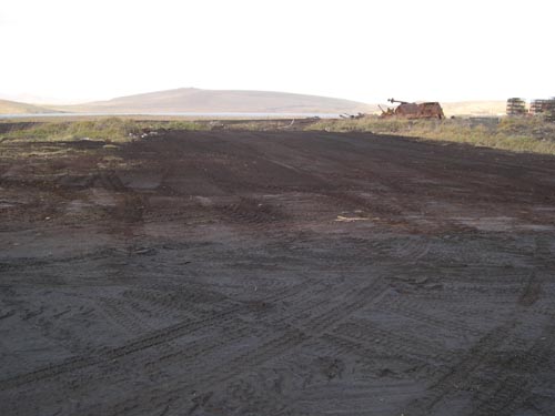 Photo of a wide expanse of bare earth at the Tract 50 Foundation site, after environmental remediation.