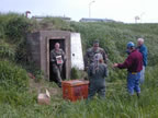 Thumbnail photo of people removing explosives from the Explosives Storage Bunker.
