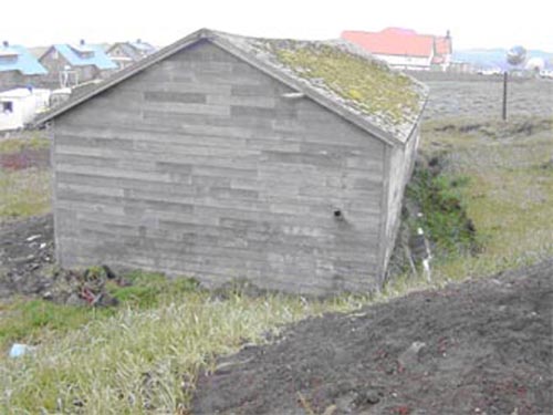 Photo of a weathered gray building.