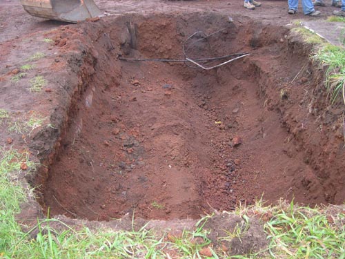 Photo of a shallow hole in the ground.