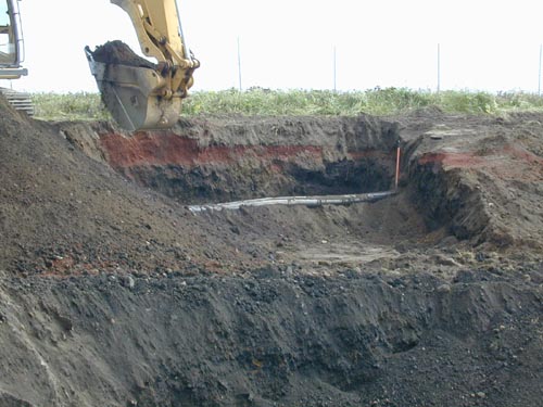 Photo of an excavator digging a hole.