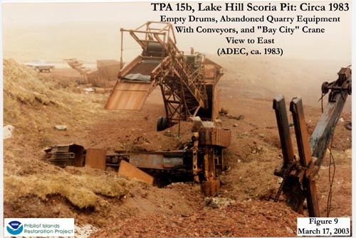 Photo of empty drums, abandoned quarry equipment with conveyors, and "Bay City" crane at Lake Hill Scoria Pit.