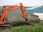 Thumbnail photo of an excavator digging a hole.