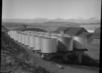Thumbnail photo of a group of large cylinders on raised platform.