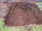 Thumbnail photo of a shallow hole in the ground.