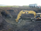 Thumbnail photo of an excavator digging in a large hole.