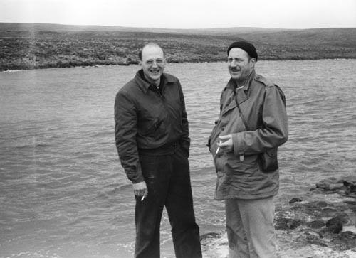 Photo of two men near water.