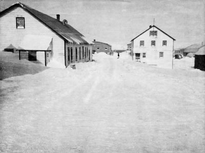 Photo of several buildings along snowy street.