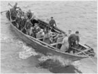 Photo of men in a canoe.