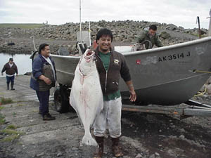 Photo of man holding a fish.